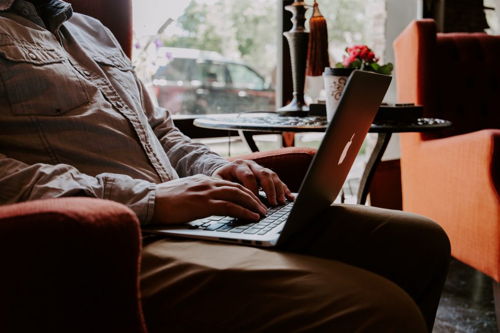 Man with laptop computer on his lap