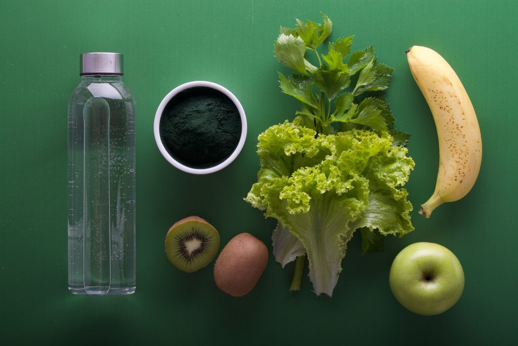 fruit and water on a green background